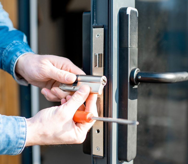 man-changing-core-of-a-door-lock-PZUZD9H.jpg